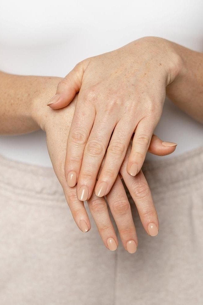 Neat nude short nails for women over 50
