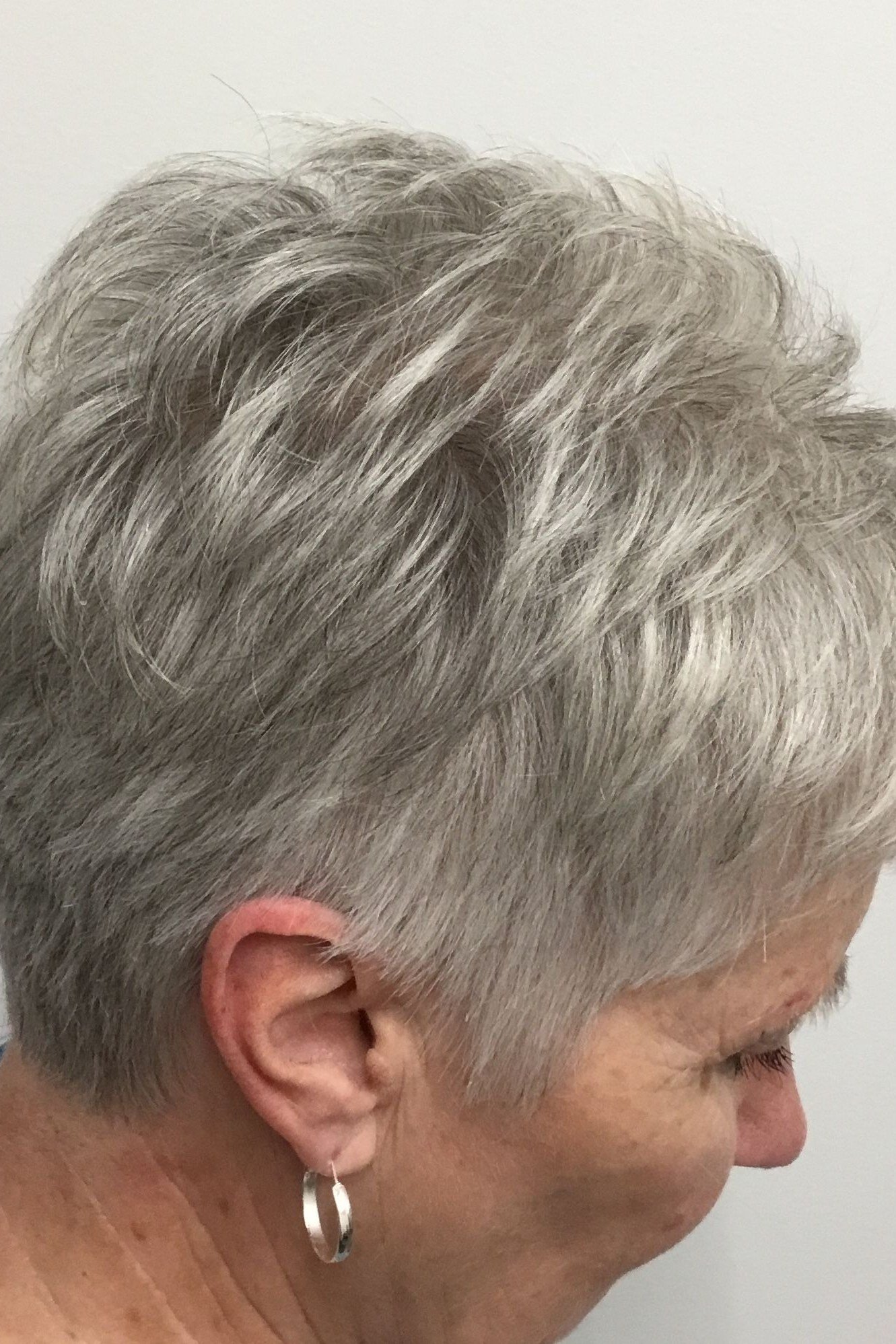 Soft gray voluminous pixie haircut for women over 50