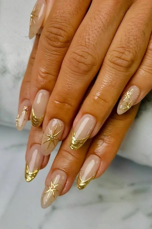 taupe and gold french tip nails on dark skin hands
