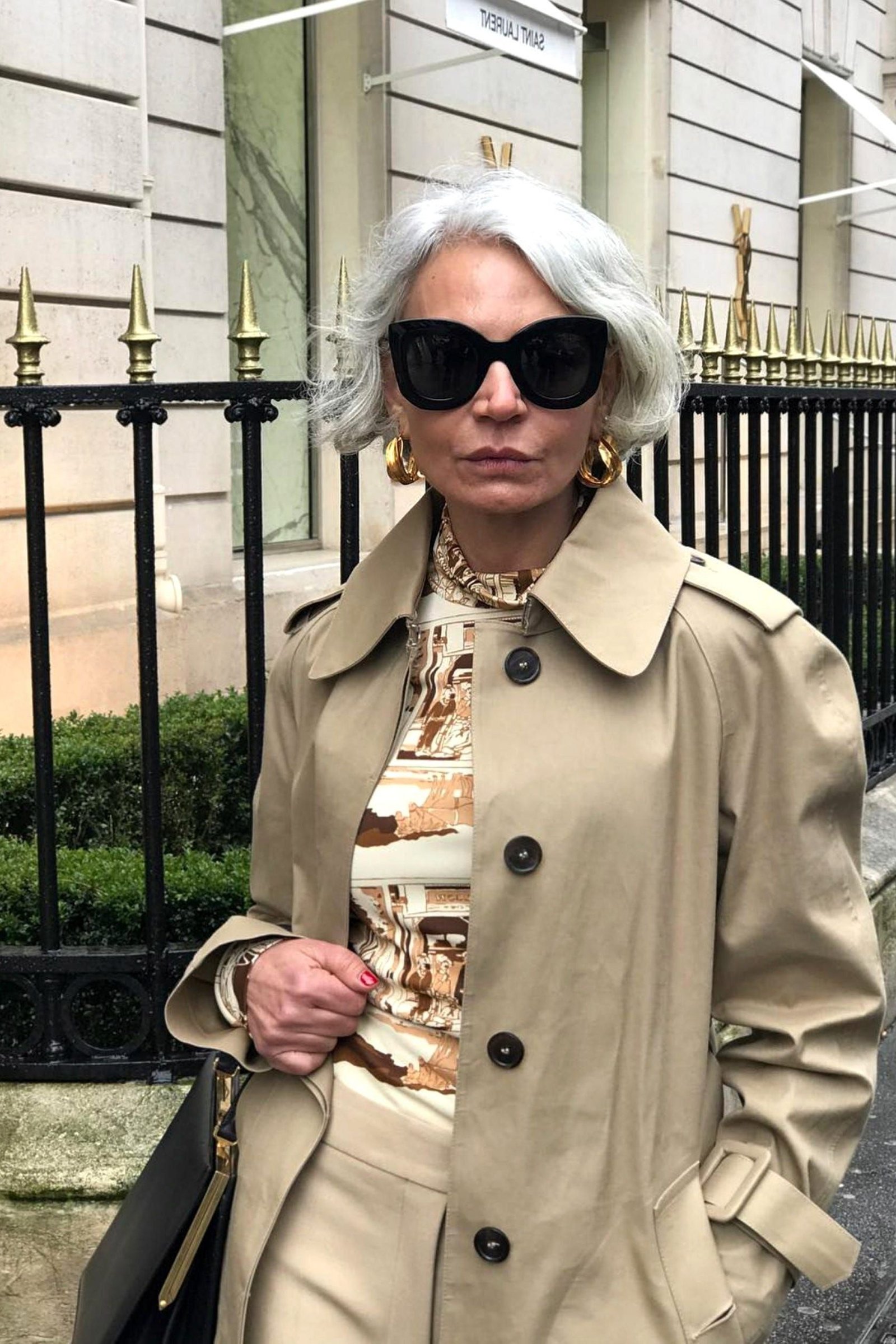 Older woman in classic beige trench coat
