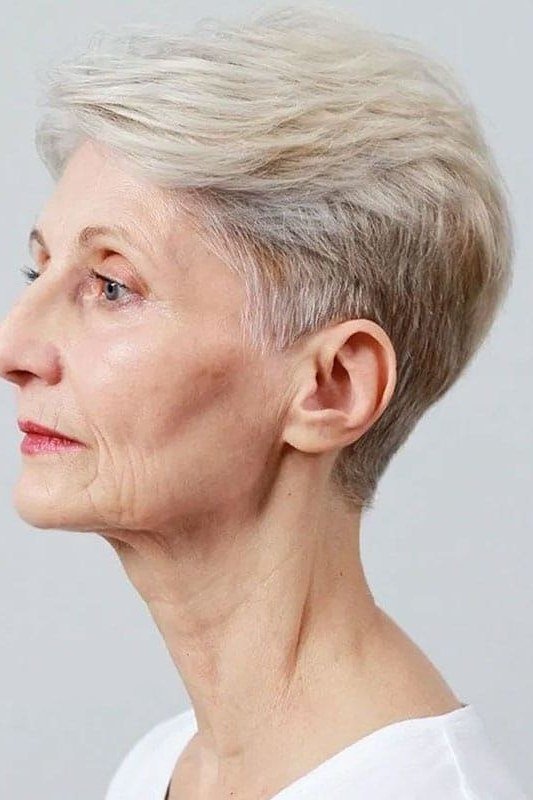 Classic silver tapered pixie, sharp side profile, studio lighting, timeless hairstyle for women over 70