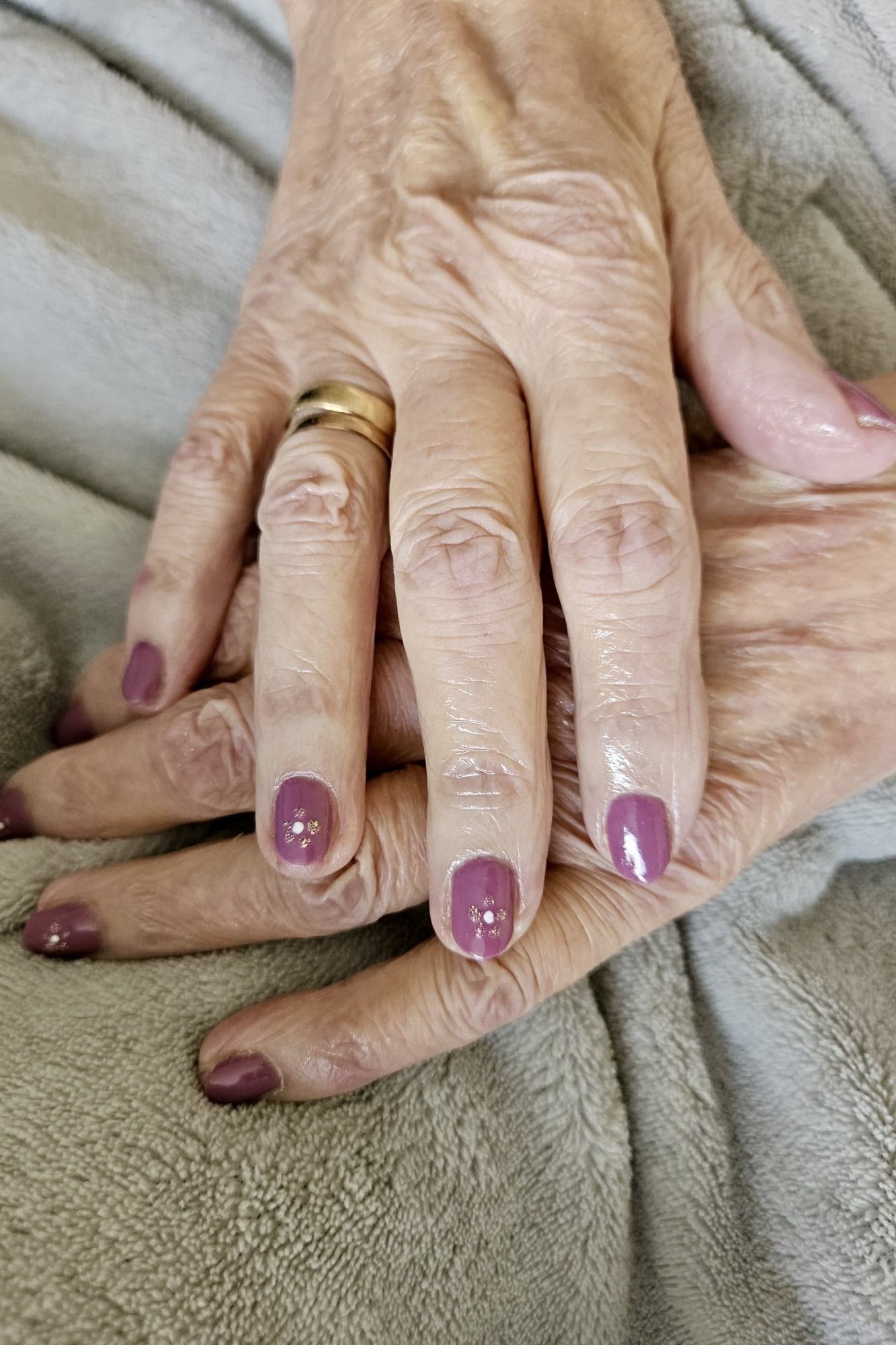 Purple Plum on Very Mature Hands gel nails for women over 60