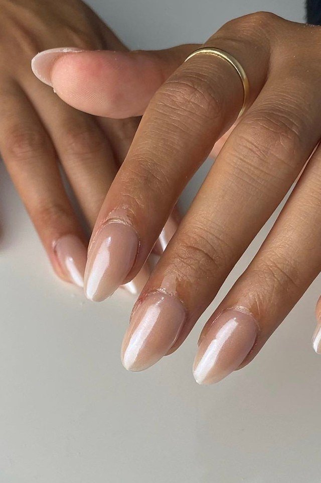 Chrome milky white almond nails glowing on dark skin