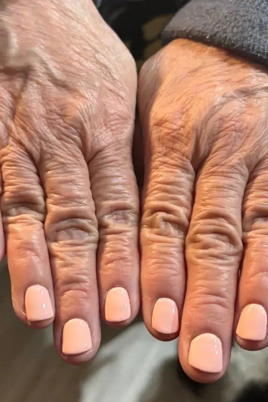 Peach Nude on Aged Hands - short nude nail idea for women over 50