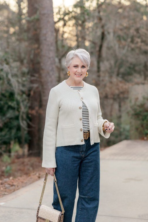 Cream jacket with striped top and wide-leg jeans, fall outfit for women over 50