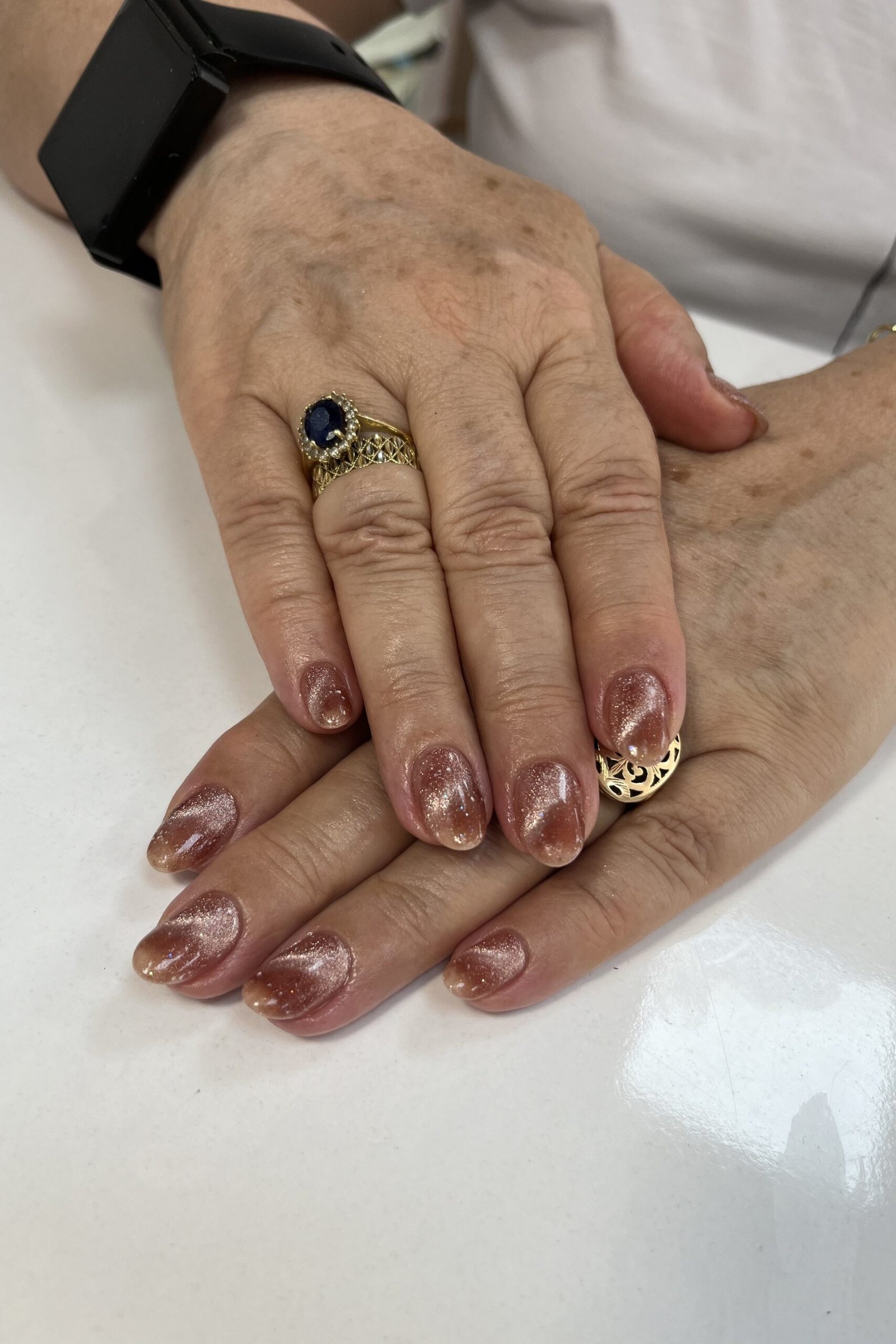 Rose Gold Cat Eye Nails - Warm rose gold shimmer glows on these short to medium oval nails.