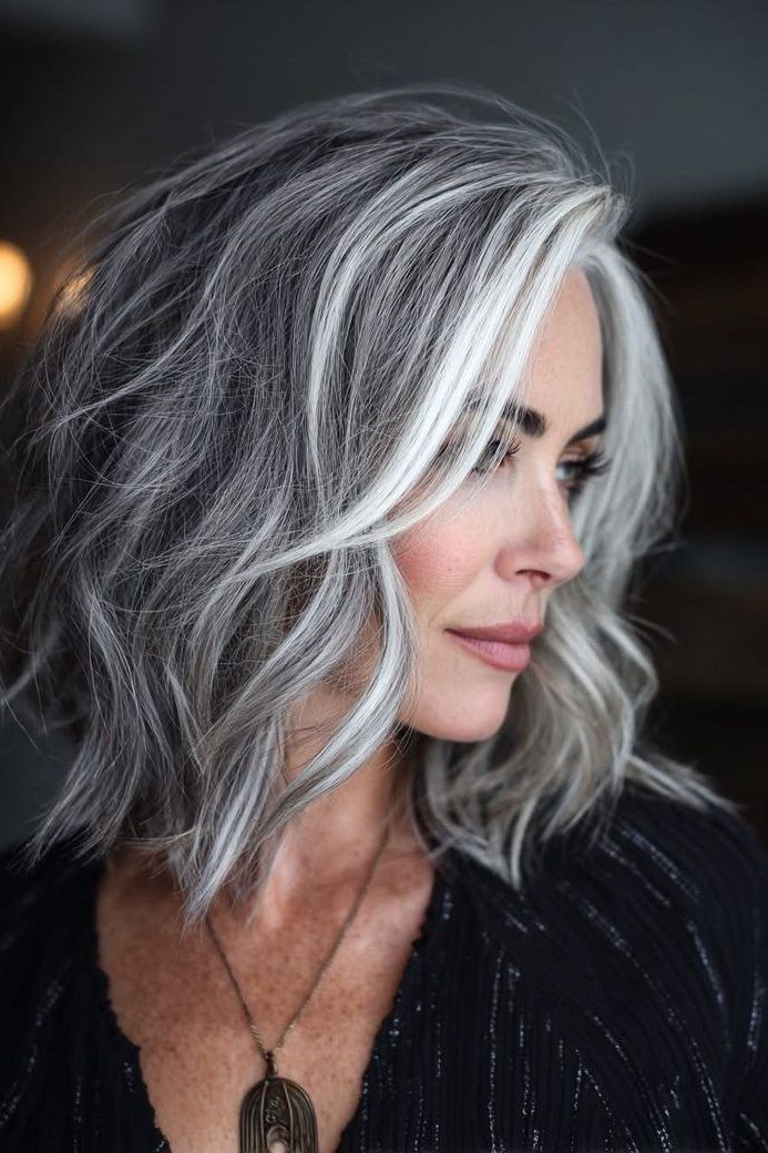 Silver long wavy layered hair, side view - wispy hairstyle for women over 40