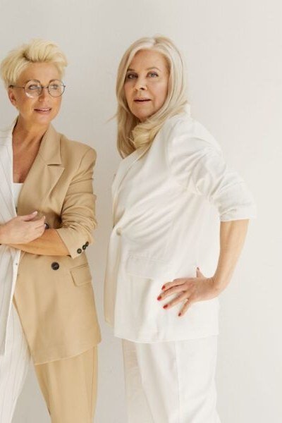 White and cream blazers on two older women, studio - business casual work outfit for women over 50