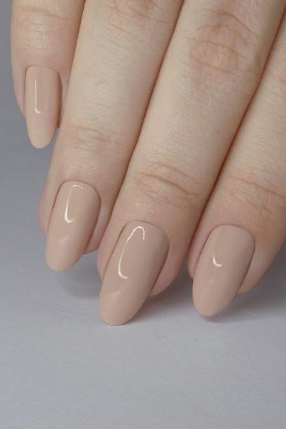 Nude almond nails on light background
