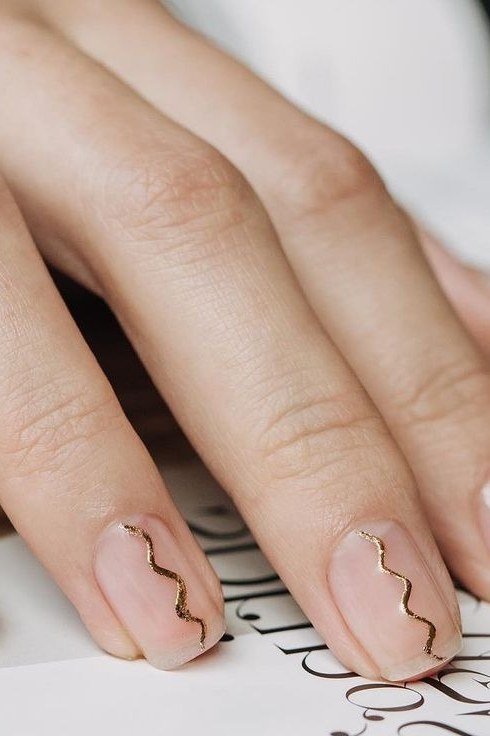 Nude nails with gold squiggle line, sophisticated nail design for women over 50