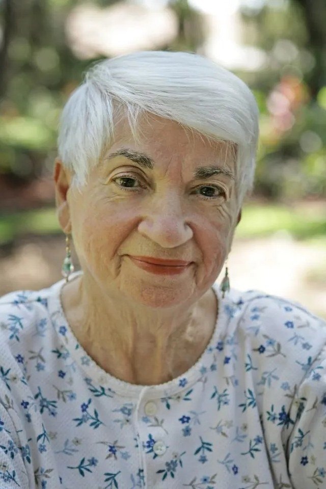 White pixie haircut with feathered texture and floral top for older women