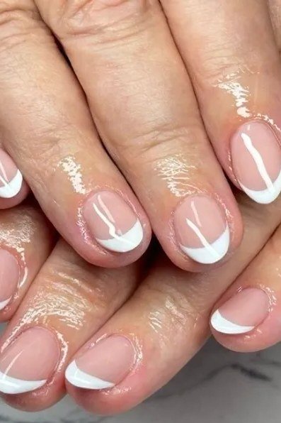 Angled white chevron french tip nails