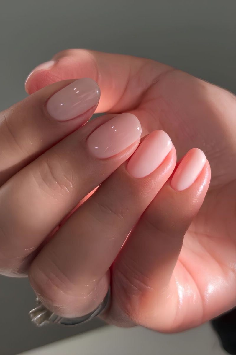 short almond/oval, sheer nude, fingers curled over palm , for women over 60