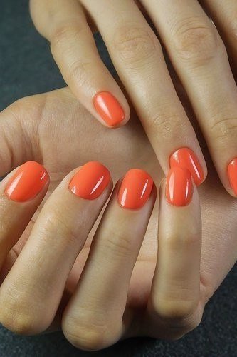 Coral nails on mature hand