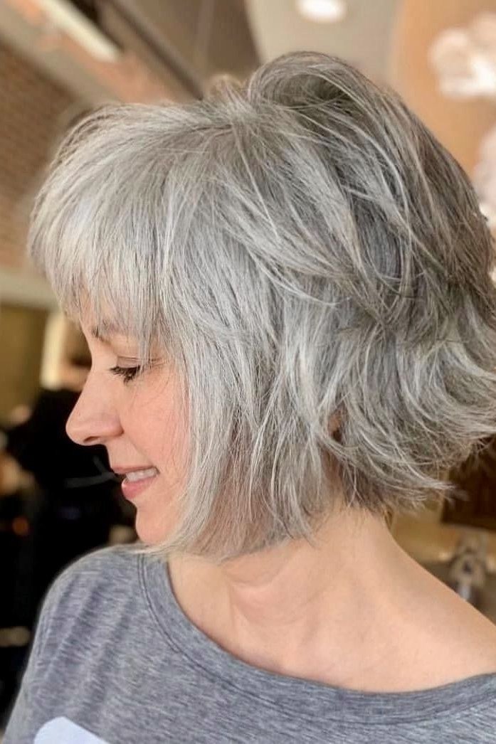 Choppy bob hairstyle for women over 60: white shaggy bob salon side view