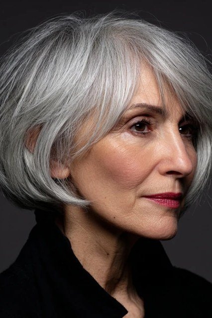 Choppy gray shaggy bob haircut for women over 60, side profile