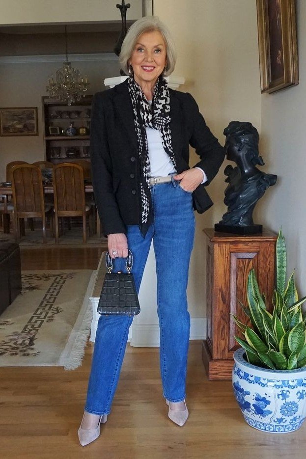 Black blazer with printed scarf and bright jeans for women over 60