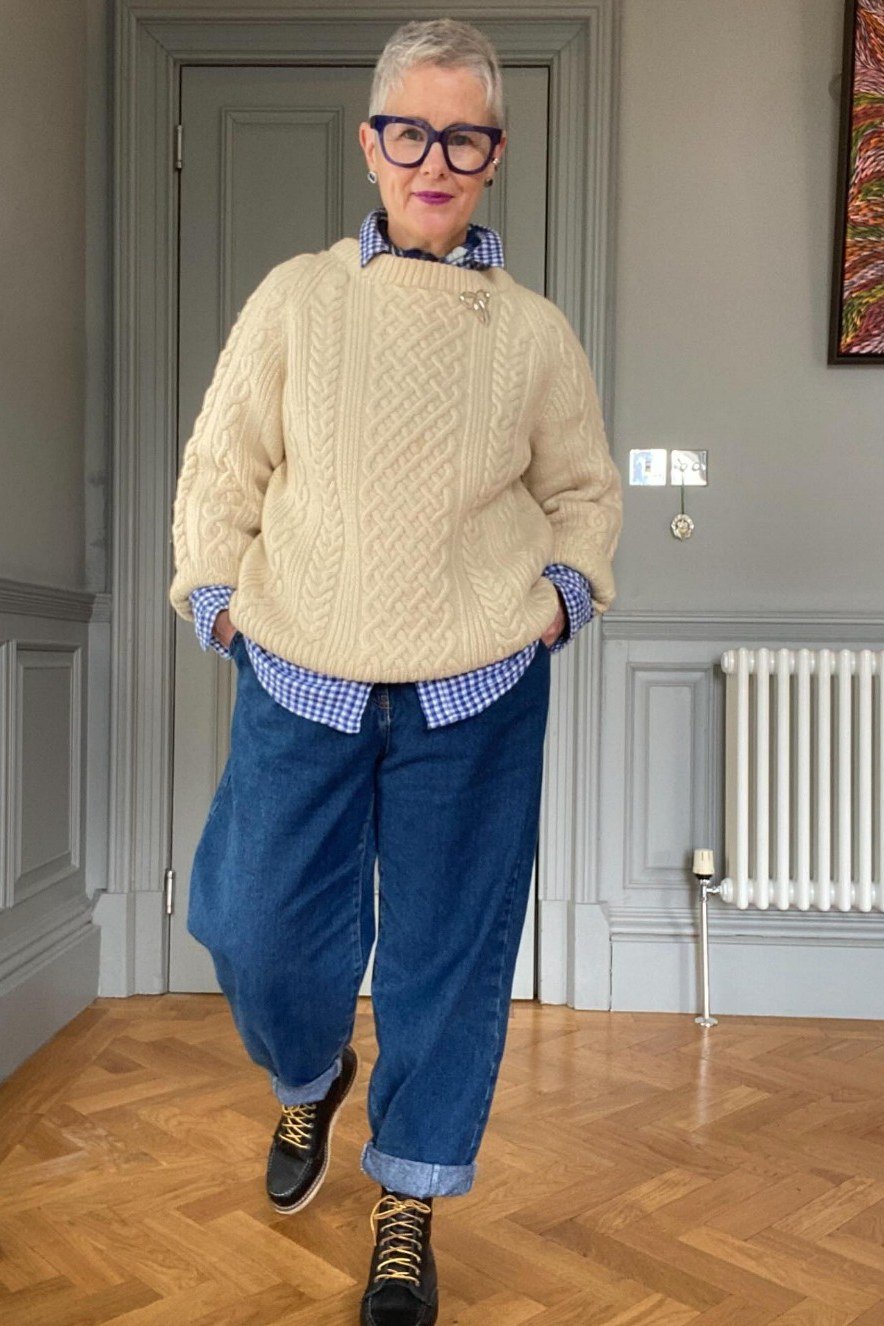 cream cable knit sweater gingham shirt dark wide leg jeans hiking boots women over 50