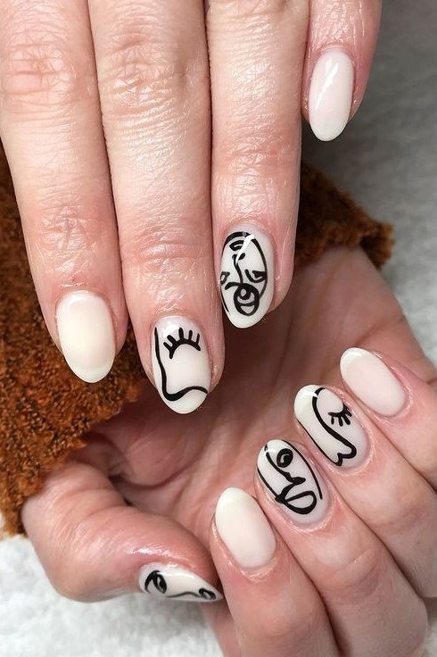 Nail art design for women over 60: nude nails with black abstract face line art