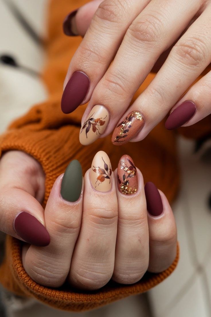 19. Matte Burgundy Nails With Autumn Leaves - Thanksgiving nail art idea for women over 50