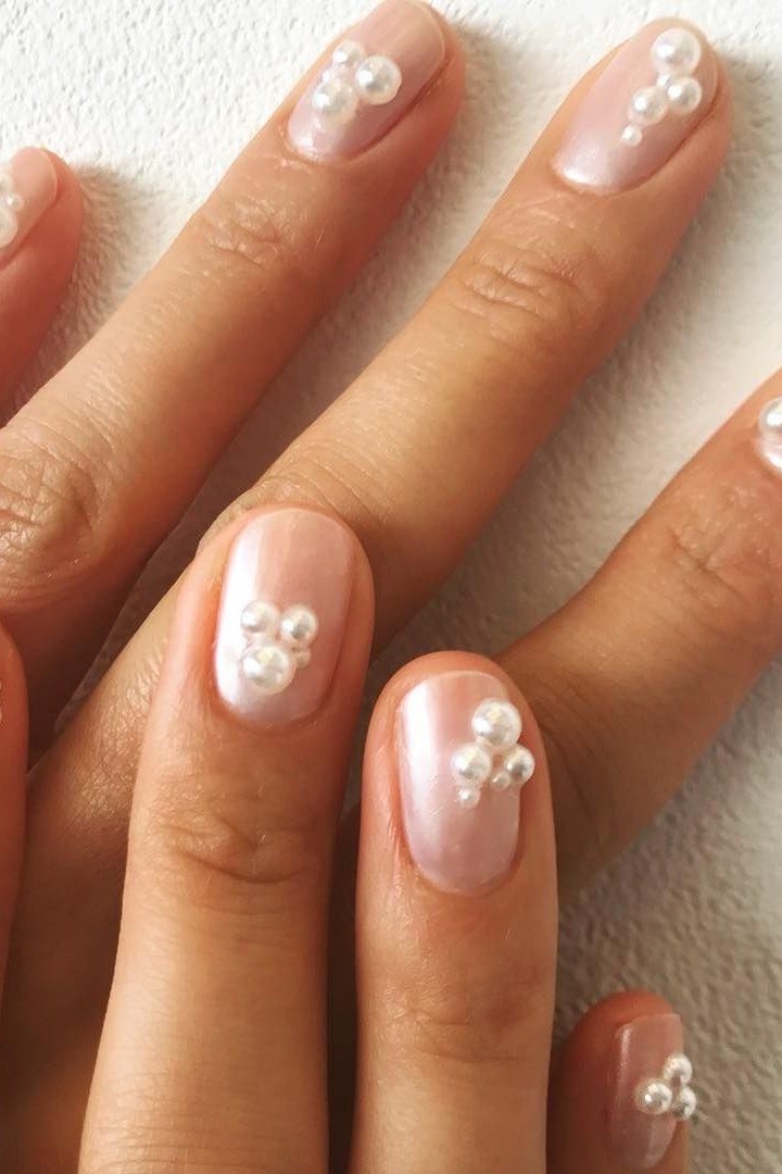 Milky Pink Pearl Nails with Flower Accents - pearl finish nail idea for women over 60
