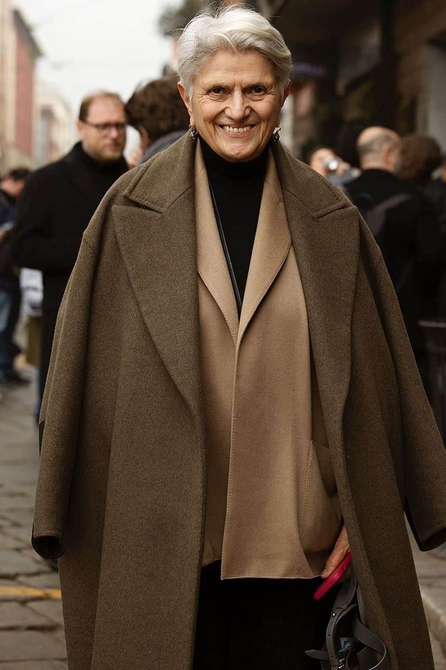 Effortlessly chic fall outfit for women over 60: olive-green coat over tan top