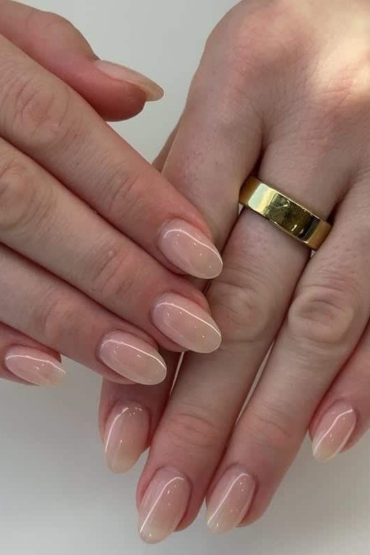 Nude almond nails with thin gold band accent, mature-ish hands - classy nail design for older women