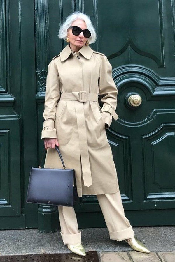 Double breasted beige trench coat with cream trousers, classic fall outfit over 50