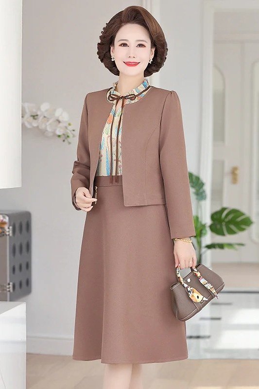 Dusty rose skirt suit with striped blouse, older woman indoor - business casual work outfit for women over 50