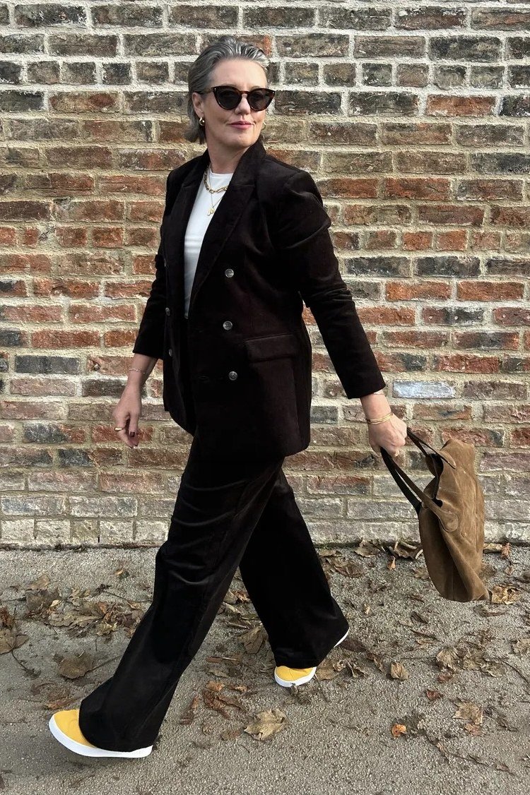 Black blazer with black wide-leg trousers and yellow sneakers