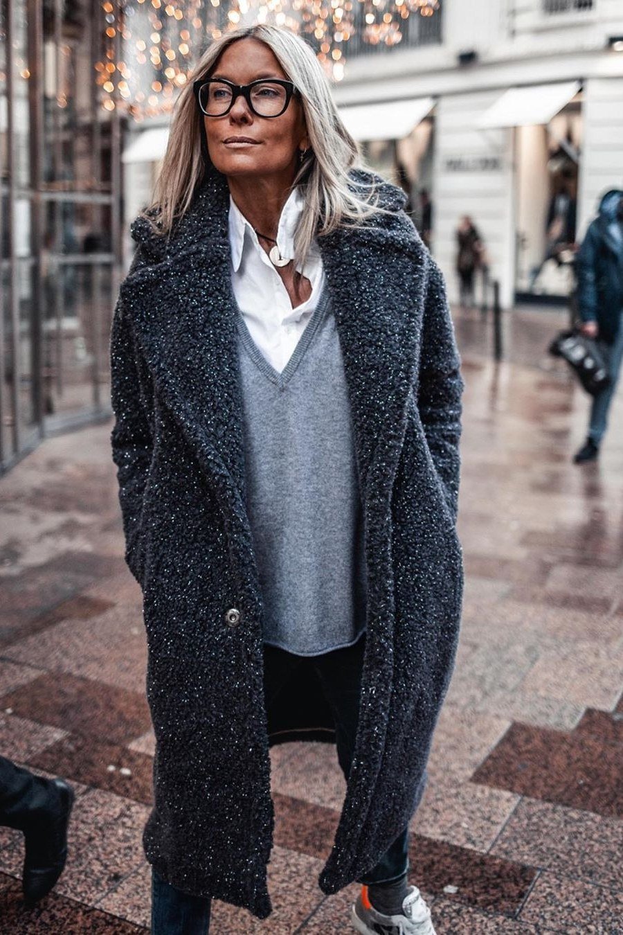 Effortlessly chic fall outfit for women over 60: textured navy boucle coat with grey sweater