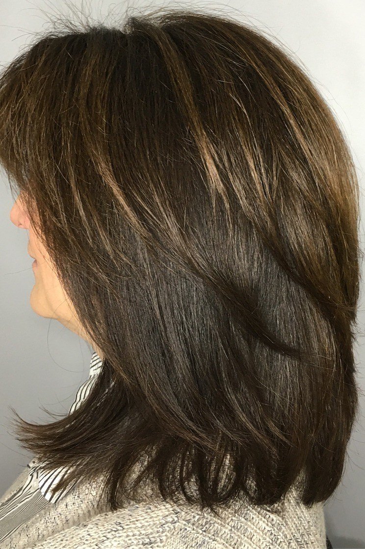 dark brown layered medium straight hairstyle, side view for women over 50