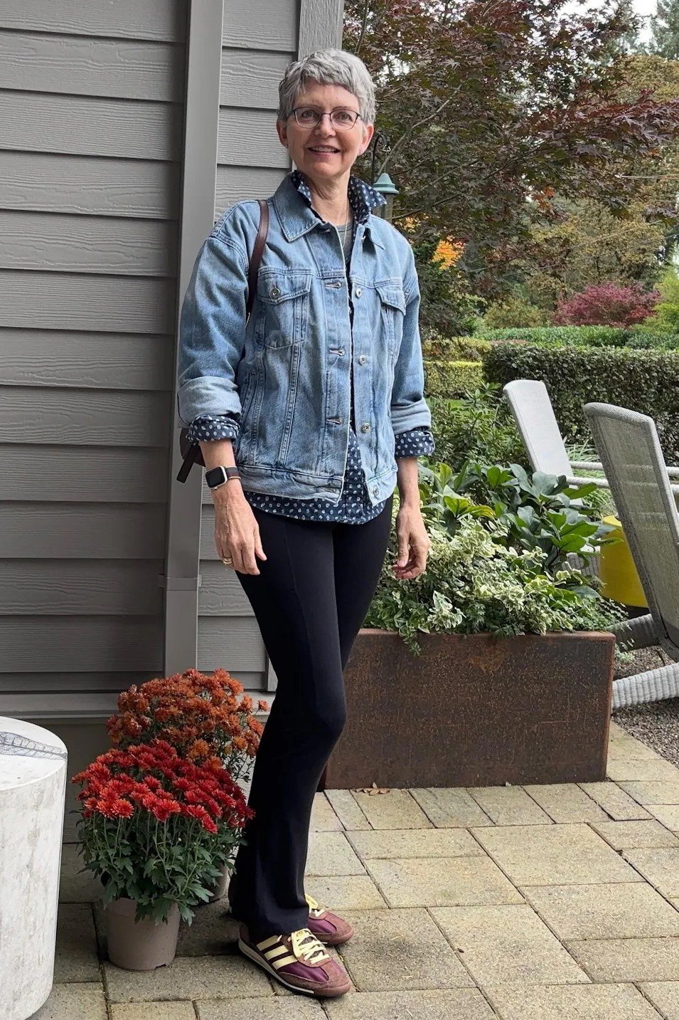 Denim jacket with black pants fall outfit idea for women over 60