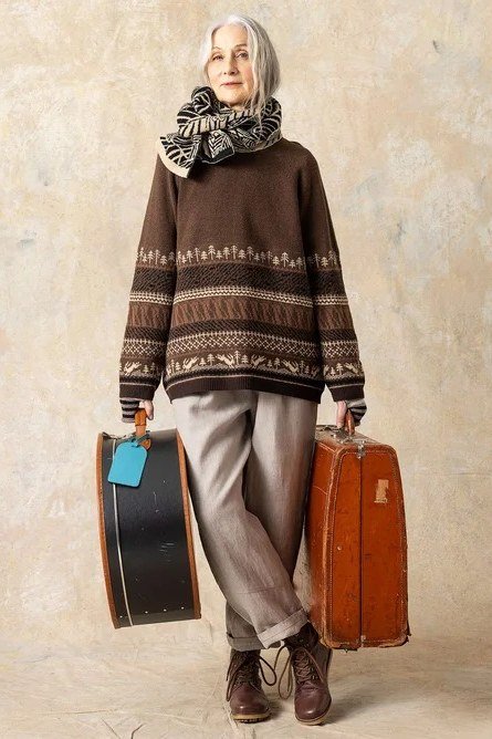 Casual fall outfit for women over 60: cream waterfall cardigan, medium wash jeans, nude flats