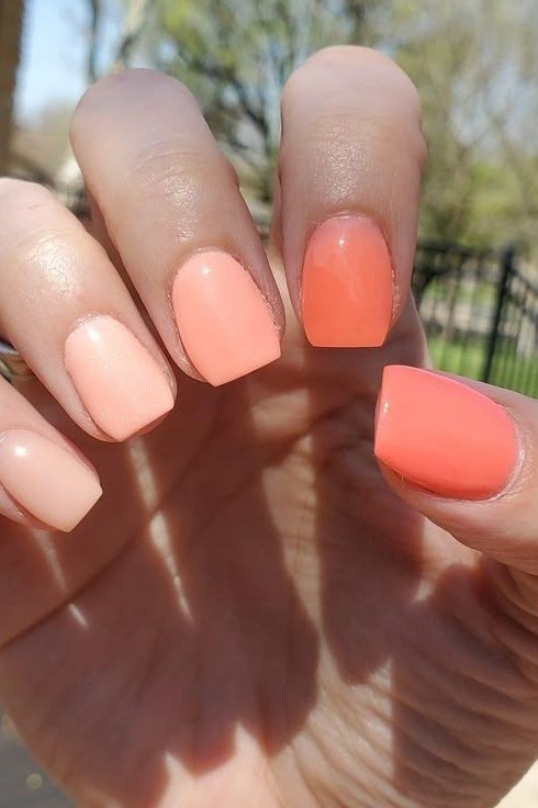 Coral ombre on short nails, outdoors, ombre nail design for women over 60