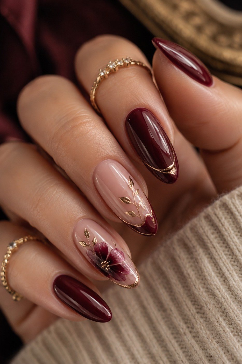 Burgundy nails with gold leaf line art for women over 50