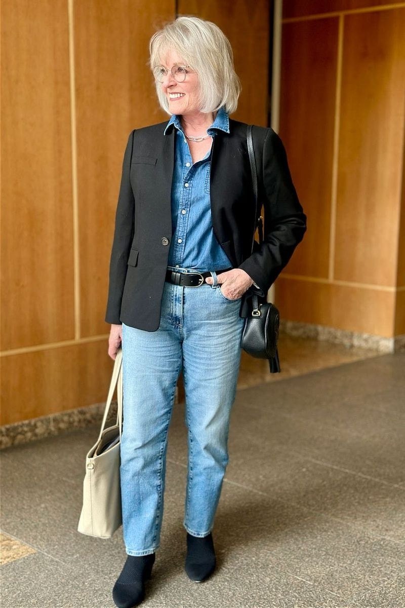 Black blazer with denim shirt and light wash jeans for women over 60