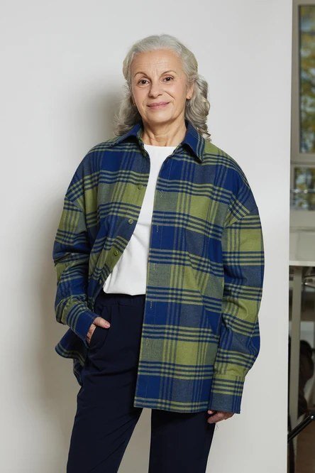 Easy casual outfit idea for women over 50: green plaid shacket over a white tee, older woman everyday style