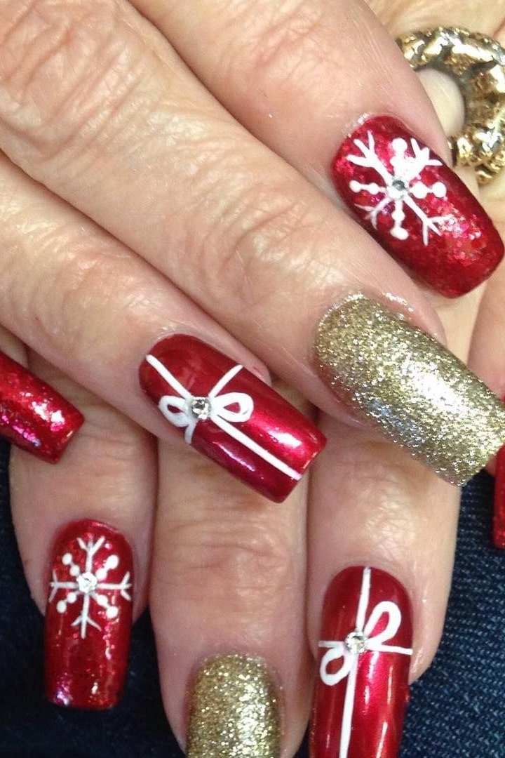 Red and gold nails with gift bow and snowflake art - classy Christmas nail idea for women over 70