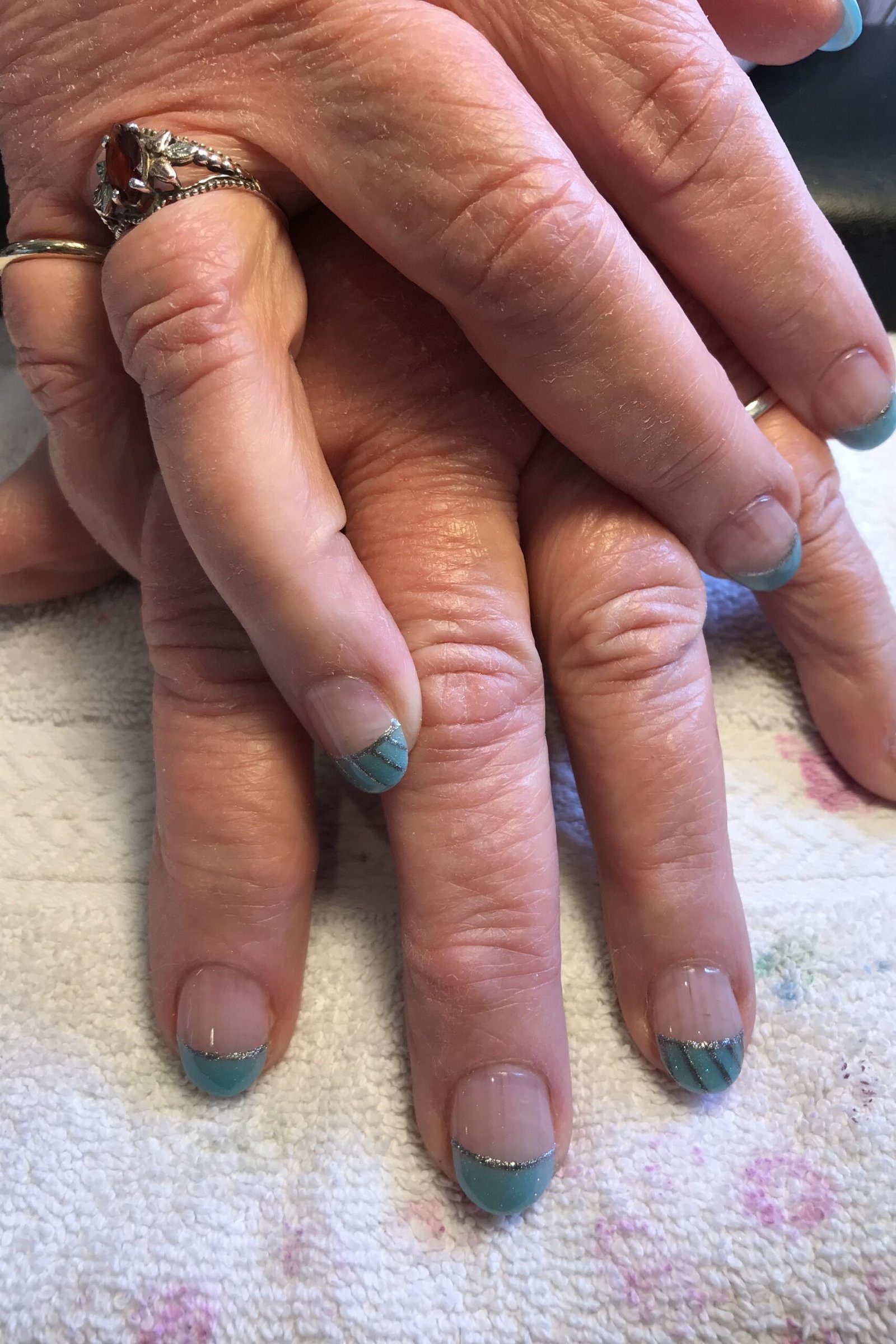 teal french tip nails on aged hands