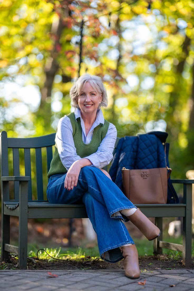 Green Sweater Vest on a Park Bench - fall outfit idea for women over 50