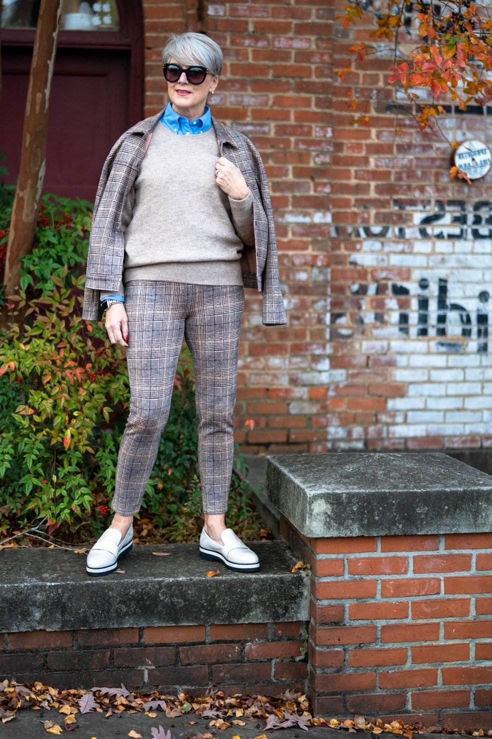 Gray plaid jacket over gray sweater with plaid trousers and white sneakers