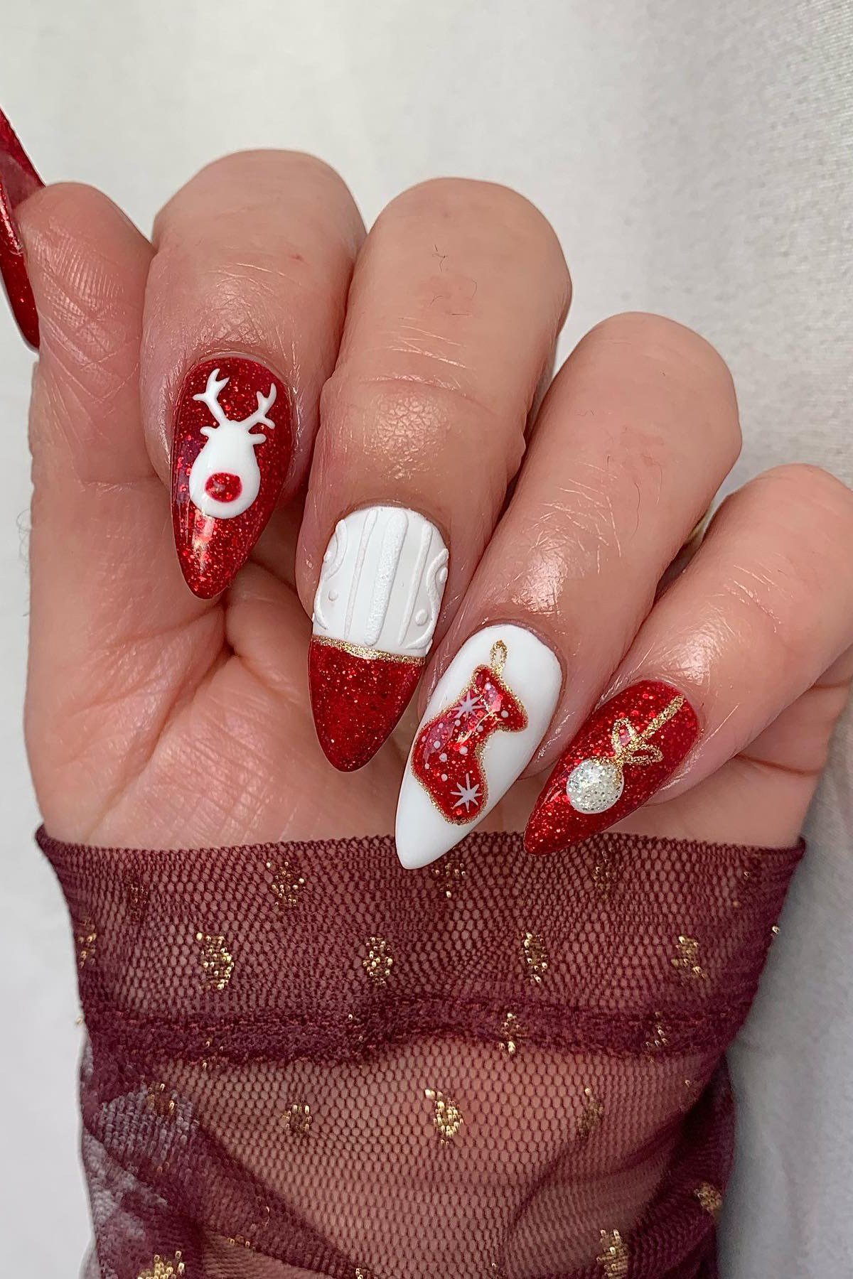 Red and white with Christmas stocking and reindeer art - Christmas nail design for older women