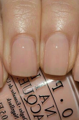 Short nude nails with OPI polish bottle