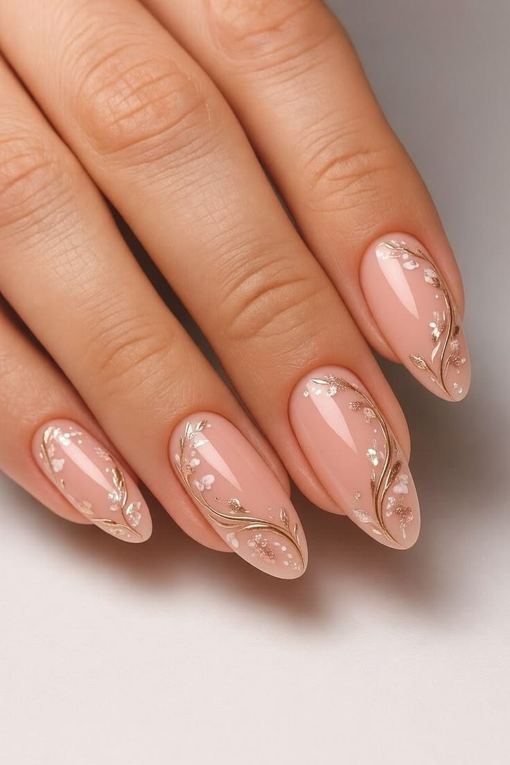 Soft pink nails with gold swirl art, sophisticated nail design for women over 50