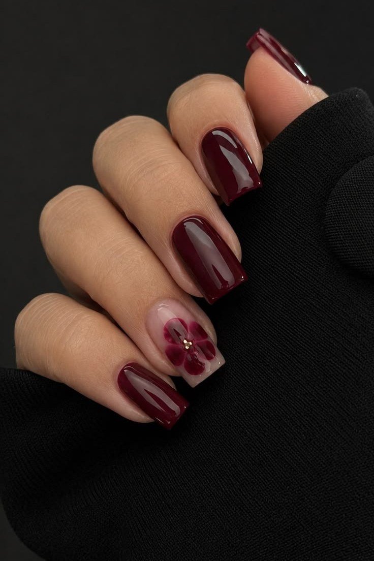 Short burgundy nails with floral accents for women over 50