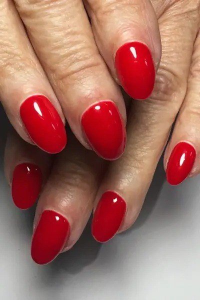 Best nails for women over 50: bright cherry red