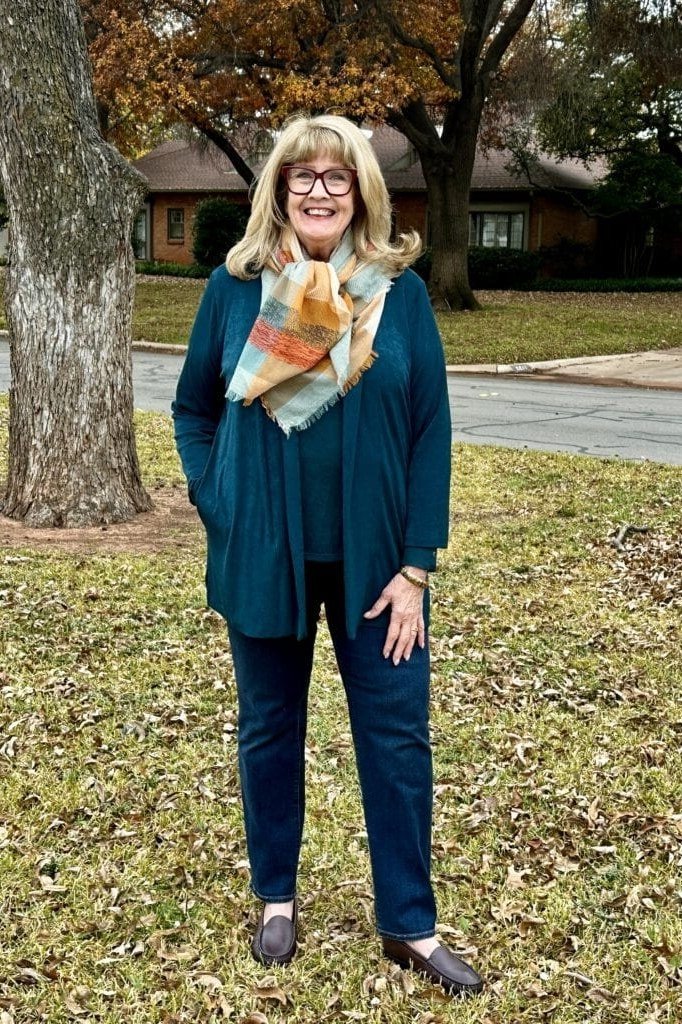 Fall city outfit for women over 50: teal cardigan jeans colorful scarf