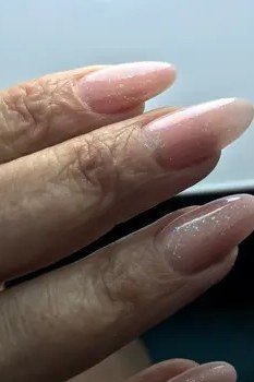 Close-Up Sheer Nude Almond gel nails for women over 60