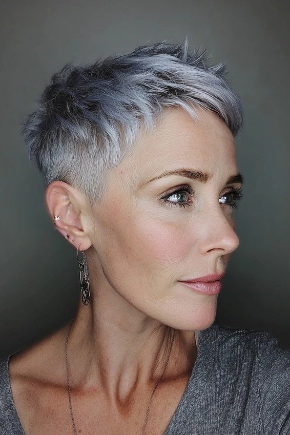 Dark silver wispy pixie haircut with sleek sides portrait for older women